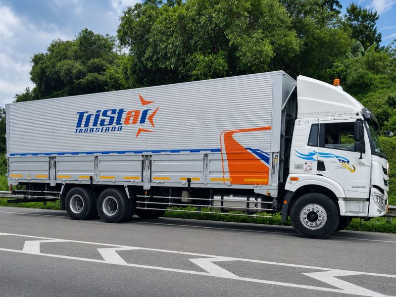 Truk box PT Tristar Transindo melaju di jalan tol